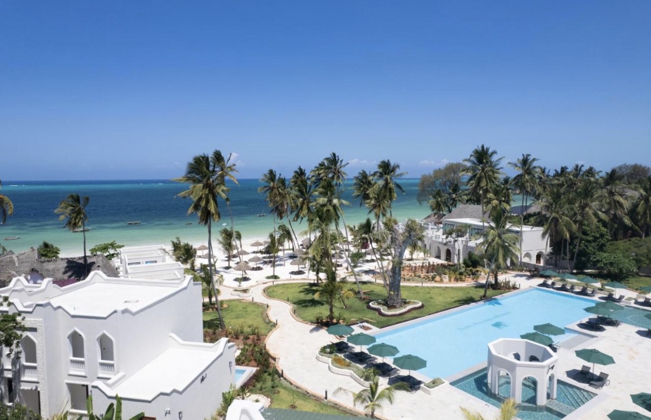 Beachfront pool, palms and the Indian Ocean at Tembo Kiwengwa Resort
