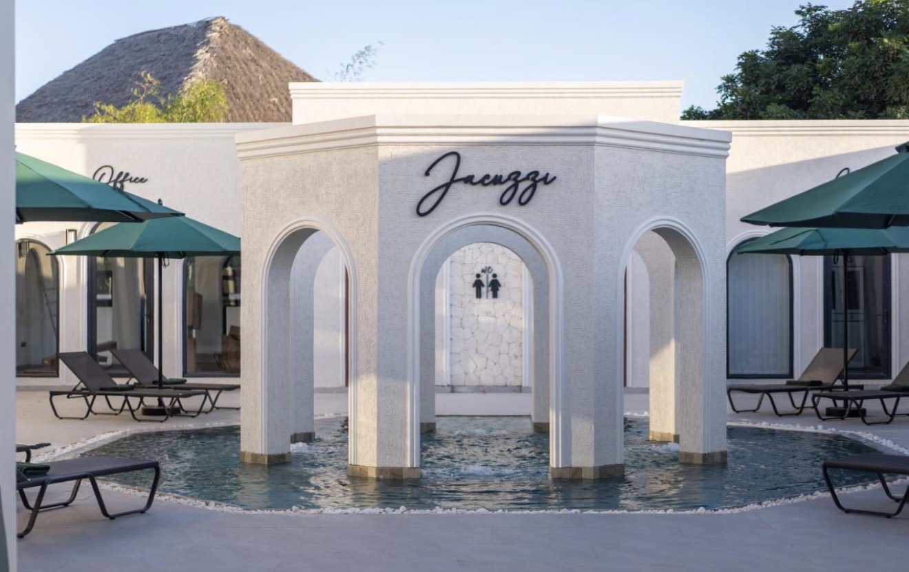 Arched jacuzzi pavilion surrounded by loungers and parasols