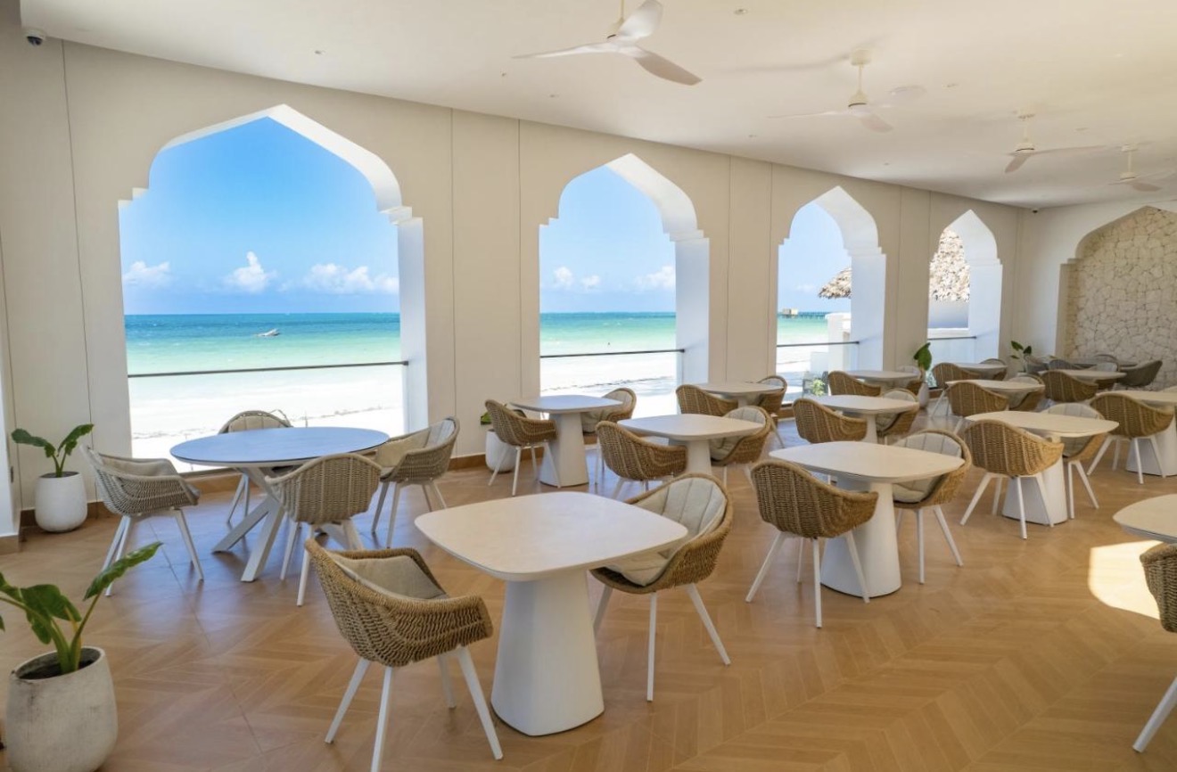 Open-air restaurant with arched windows facing the beach
